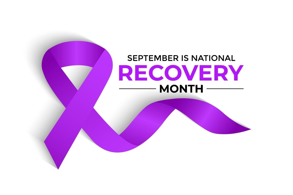 Purple ribbon with the text "September is National Recovery Month" on a white background, symbolizing awareness and support for recovery efforts like outpatient rehab in Nashville TN.