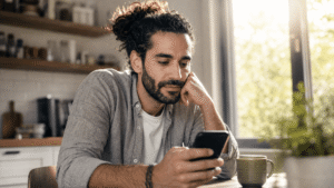 Man reading about the Tennessee kratom ban on his phone, considering next steps for kratom dependence treatment