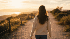 person walking forward on a sunlit path representing life and recovery after intensive outpatient program ends